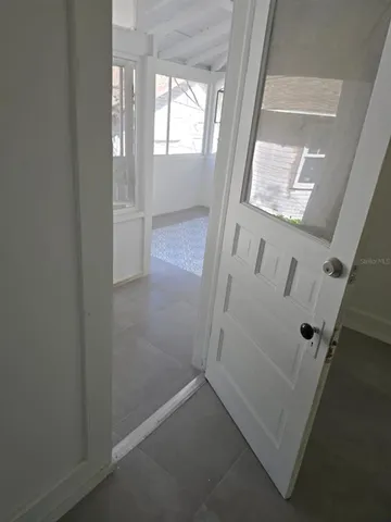 a view of a livingroom with a ceiling fan a fireplace and window