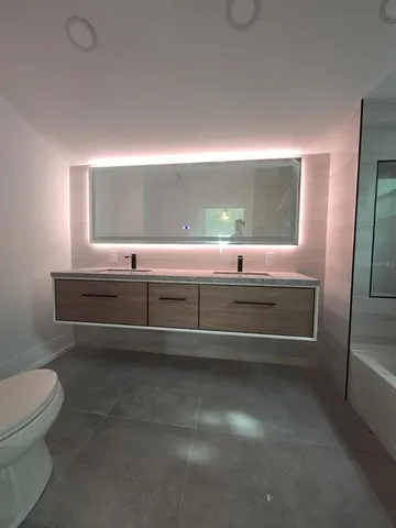 a view of room with a baby crib and a fireplace