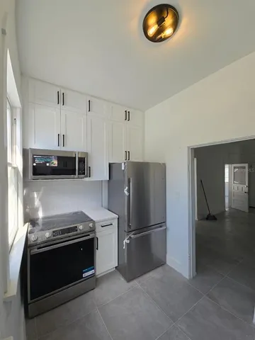 a kitchen with stainless steel appliances granite countertop a refrigerator and a stove