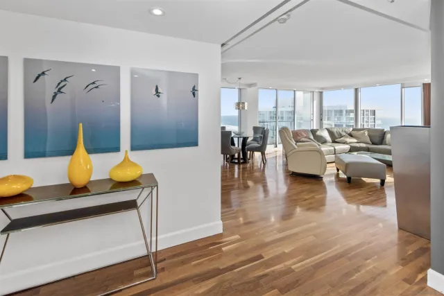 a living room with furniture and wooden floor