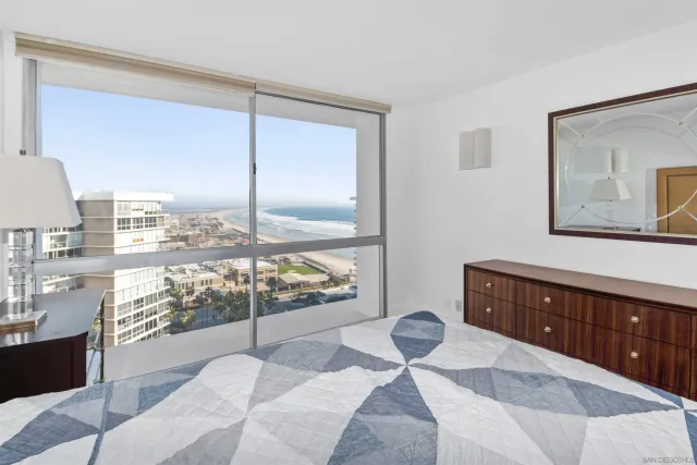 a bedroom with a bed and large window