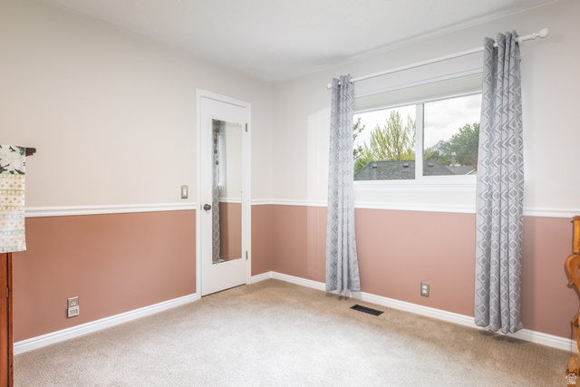 10183 Hickory Point Drive Sandy, UT 84092 - Photo 18 of 36 Room featuring light-colored carpeting, two-tone painted walls with chair rail molding, and a window with white trim