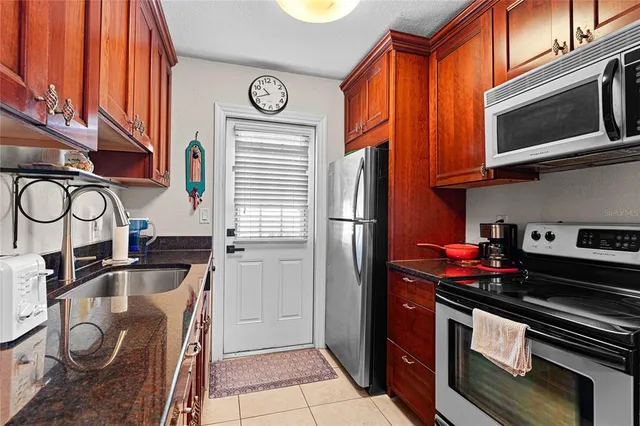 a living room with furniture a flat screen tv and a dining table