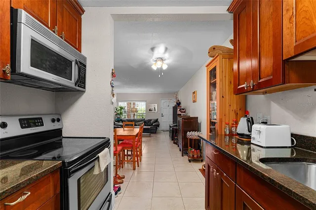 a bedroom with a bed a dresser and window