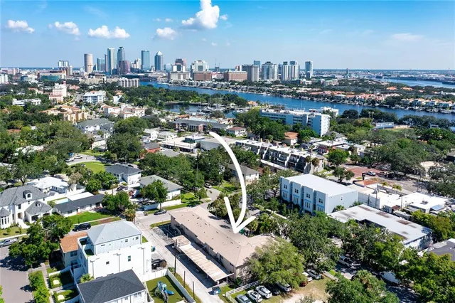 an aerial view of a houses with a swimming pool