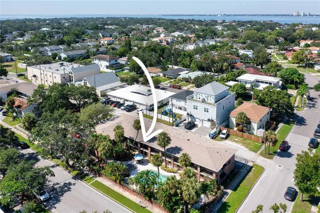 an aerial view of a house with a mountain