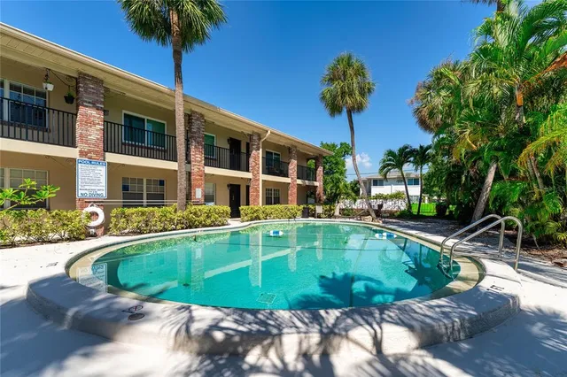a view of a backyard with swimming pool