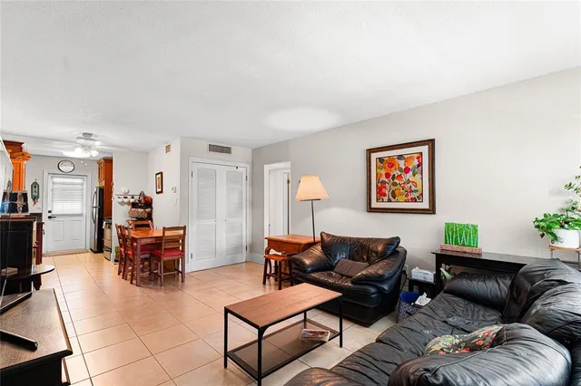 a living room with furniture a couch and a flat screen tv