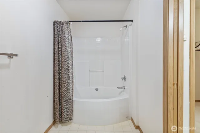 a white bath tub sitting next to a shower