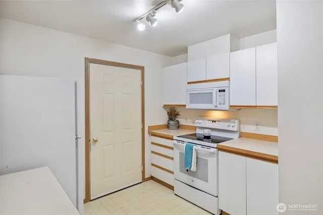 a kitchen with stainless steel appliances granite countertop a stove and a refrigerator