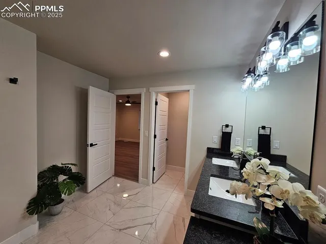 a spacious bathroom with a sink and a mirror