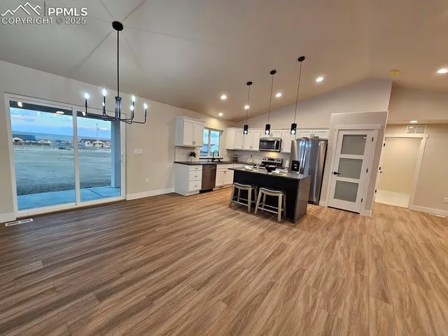 a view of a kitchen and dining room