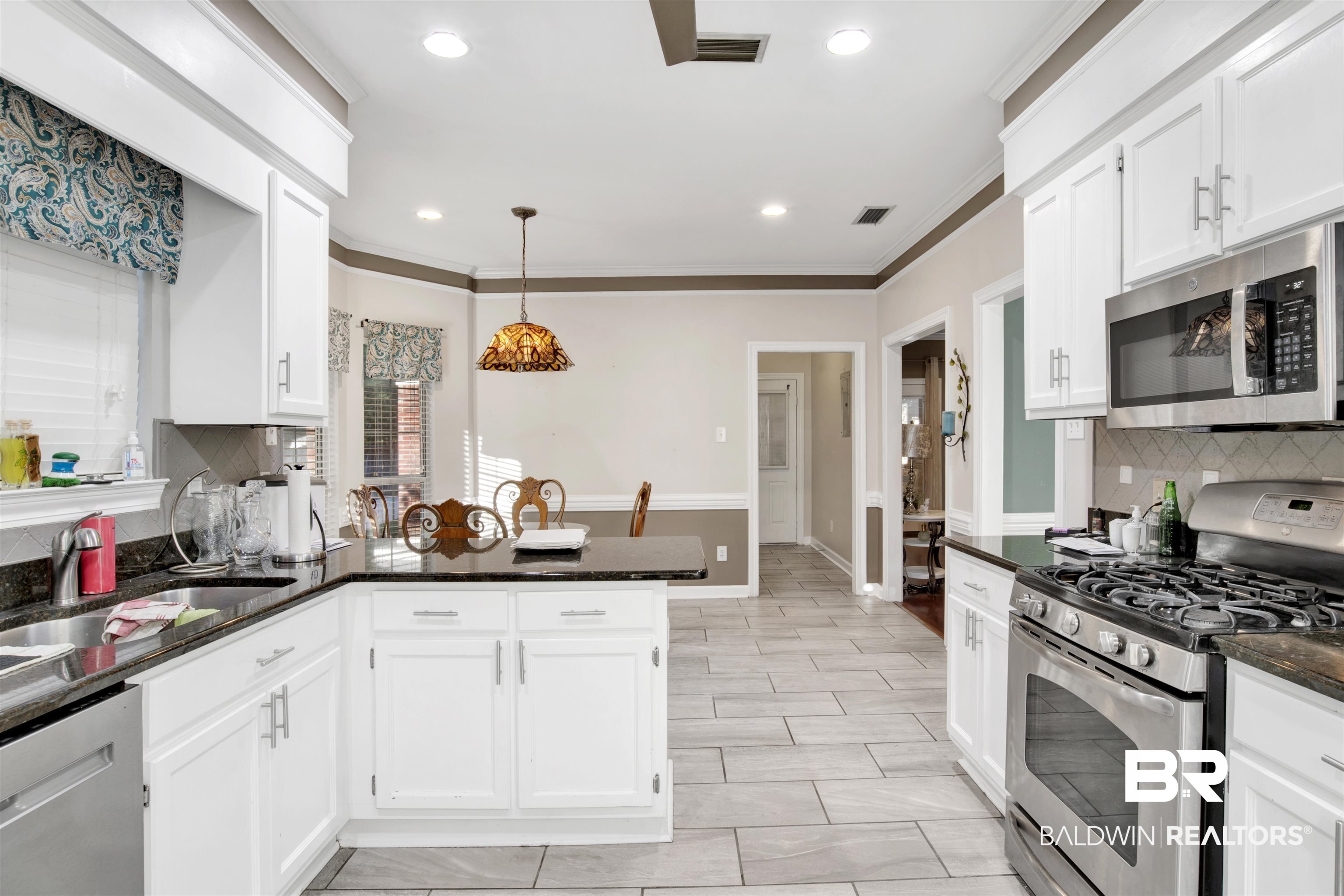 445 Wedgefield Drive South Mobile, AL 36608 - Photo 3 of 36 Kitchen with white cabinets, pendant lighting, stainless steel appliances, and tasteful backsplash