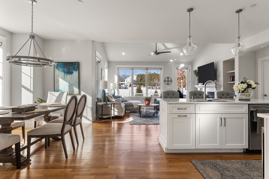 15 Rowell Lane, Unit 15 Middleton, MA 01949 - Photo 12 of 39 a kitchen with stainless steel appliances kitchen island granite countertop a stove a refrigerator and a wooden floor