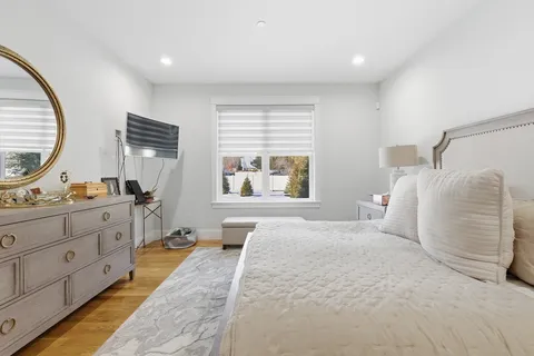 a spacious bedroom with a large bed and a window