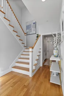 a view of entryway and hall with wooden floor