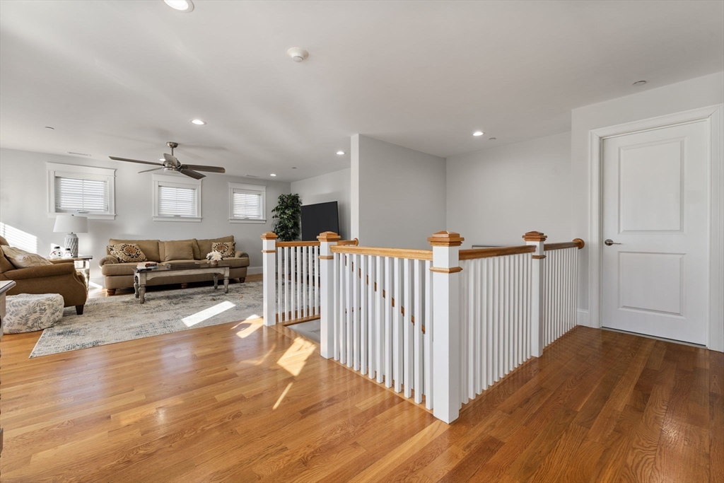 15 Rowell Lane, Unit 15 Middleton, MA 01949 - Photo 25 of 39 a view of a hallway with wooden floor and furniture