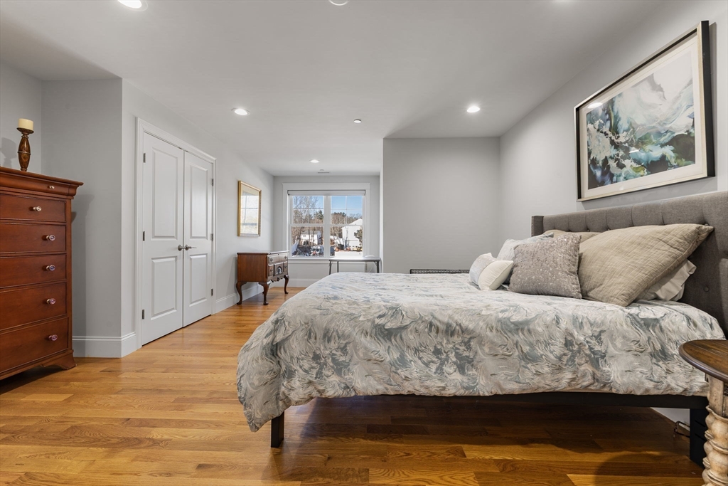 15 Rowell Lane, Unit 15 Middleton, MA 01949 - Photo 28 of 39 a bed room with a bed and a painting