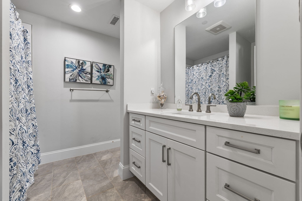 15 Rowell Lane, Unit 15 Middleton, MA 01949 - Photo 30 of 39 a bathroom with a sink and a mirror