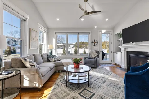 a living room with fireplace furniture and a flat screen tv