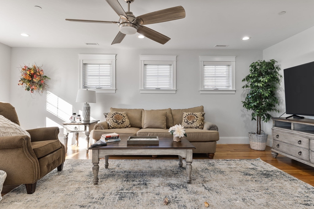 15 Rowell Lane, Unit 15 Middleton, MA 01949 - Photo 32 of 39 a living room with furniture a flat screen tv and a window