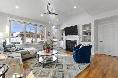 a living room with furniture fireplace and a flat screen tv