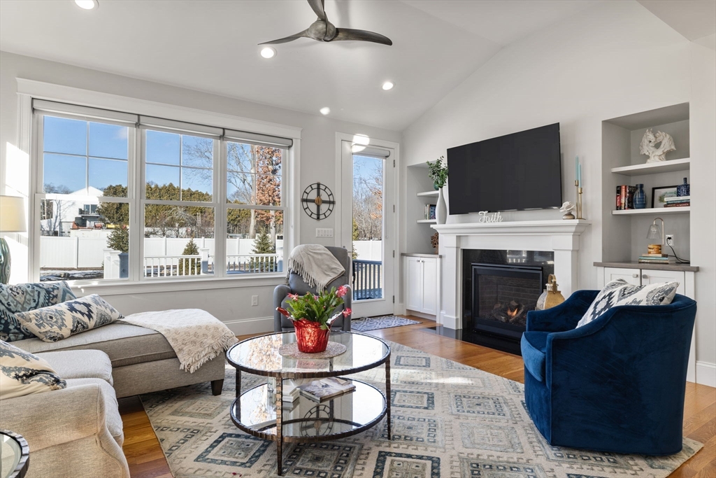 15 Rowell Lane, Unit 15 Middleton, MA 01949 - Photo 6 of 39 a living room with furniture a fireplace and a flat screen tv