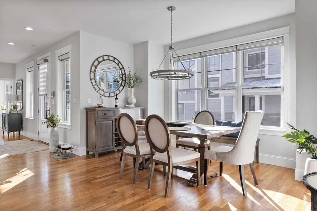 15 Rowell Lane, Unit 15 Middleton, MA 01949 - Photo 7 of 39 a view of a dining room with furniture window and wooden floor