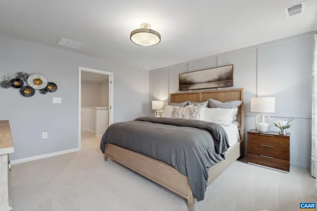 a bedroom with a bed and a lamp