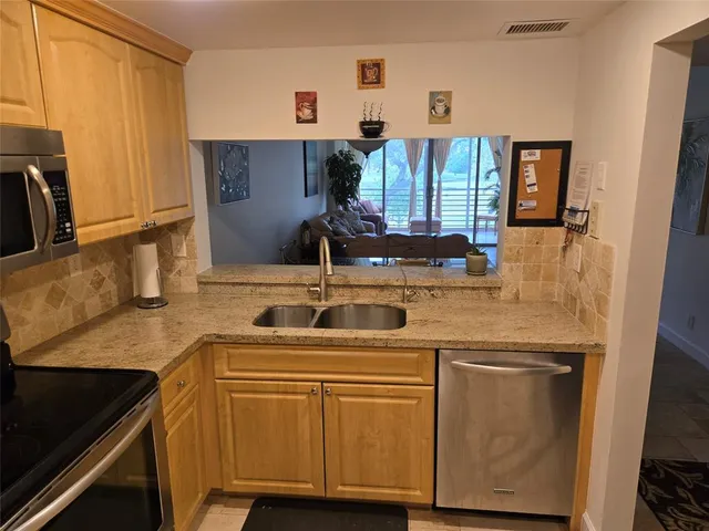a view of a porch with furniture and a yard