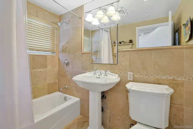 a bedroom with furniture and a large window