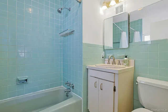 a spacious bedroom with a bed and a flat screen tv