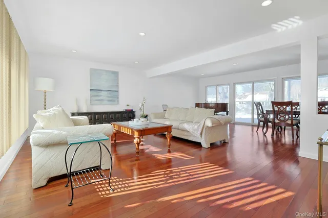 a living room with furniture wooden floor and a table