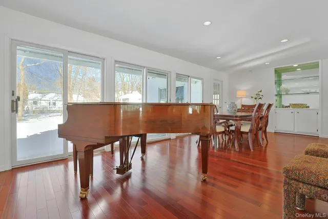 a dining room with furniture and wooden floor