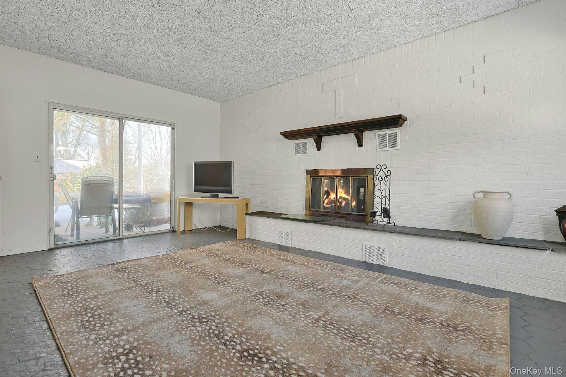 32 Lambert Lane New Rochelle, NY 10804 - Photo 8 of 27 Family room brick fpl sliders to patio