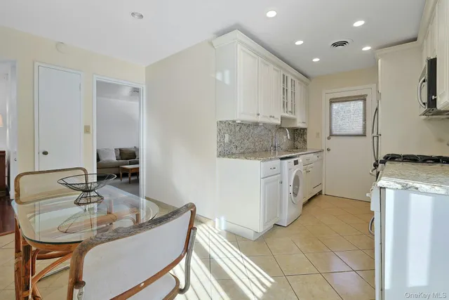 a kitchen with stainless steel appliances granite countertop a sink stove and microwave