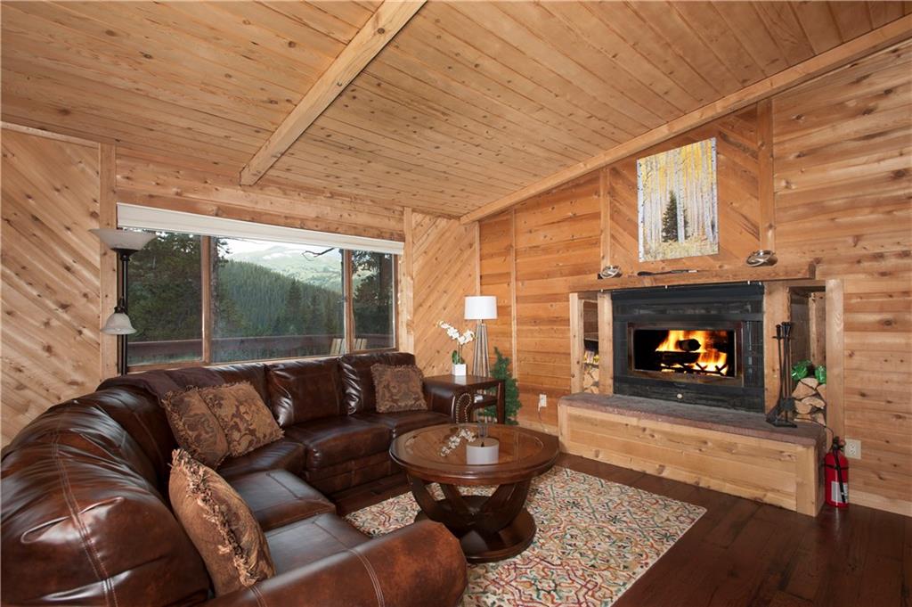 a living room with furniture a fireplace and a table