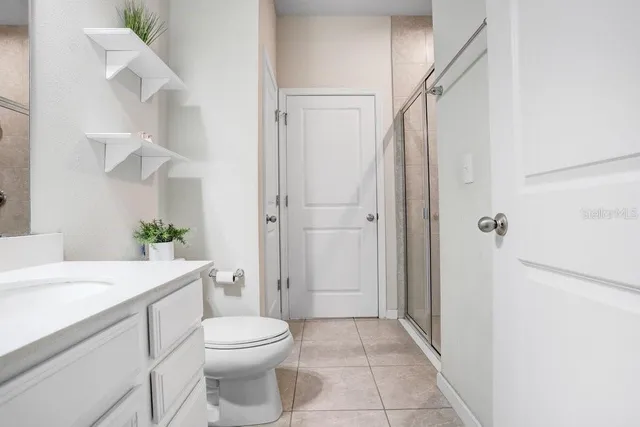 a view of a hallway with couches and dining table