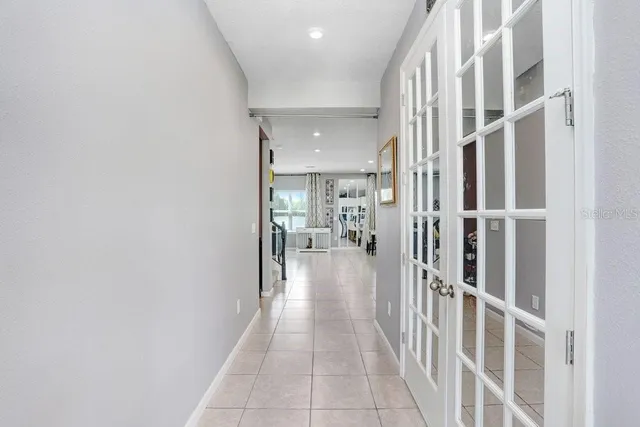 a kitchen with stainless steel appliances kitchen island granite countertop a sink refrigerator and cabinets