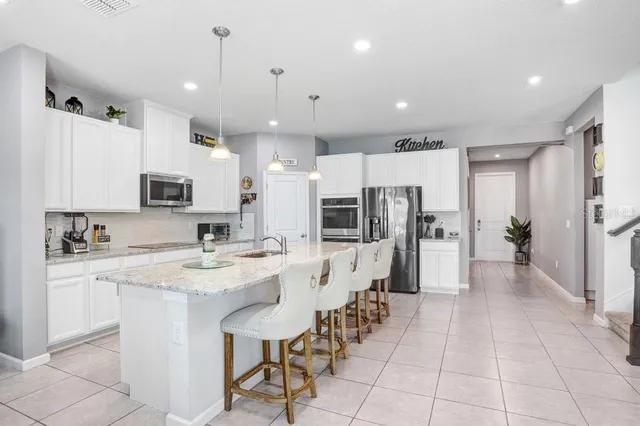 a large kitchen with a table and chairs