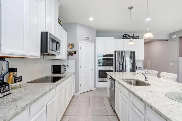 a large kitchen with lots of counter space and sink