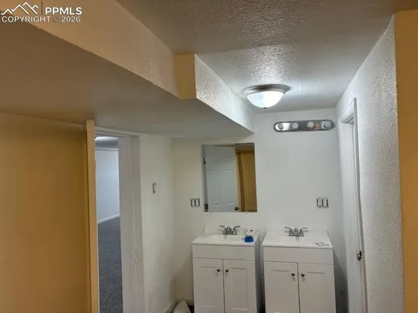 a bathroom with a sink toilet and mirror