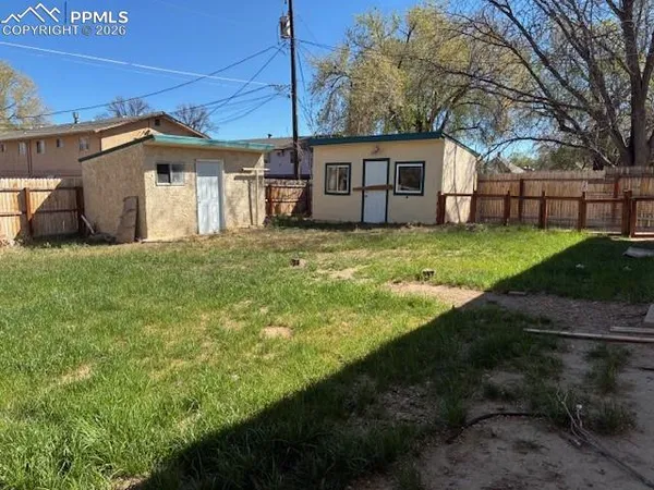 a view of a house with yard and a garden