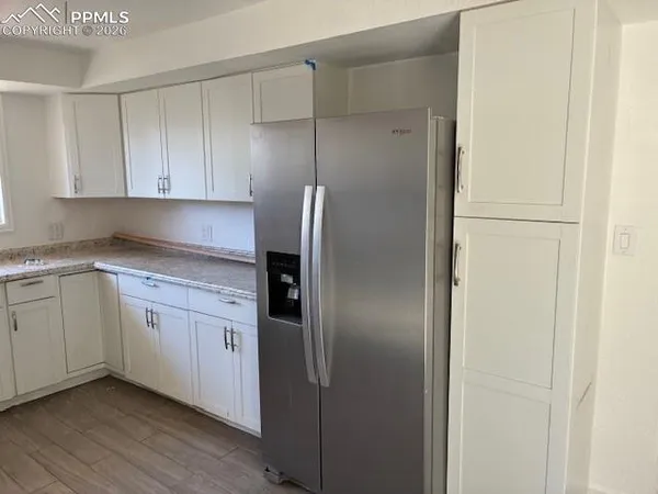 a kitchen with cabinets and stainless steel appliances