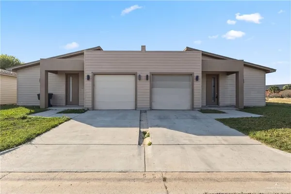 a front view of a house with garage