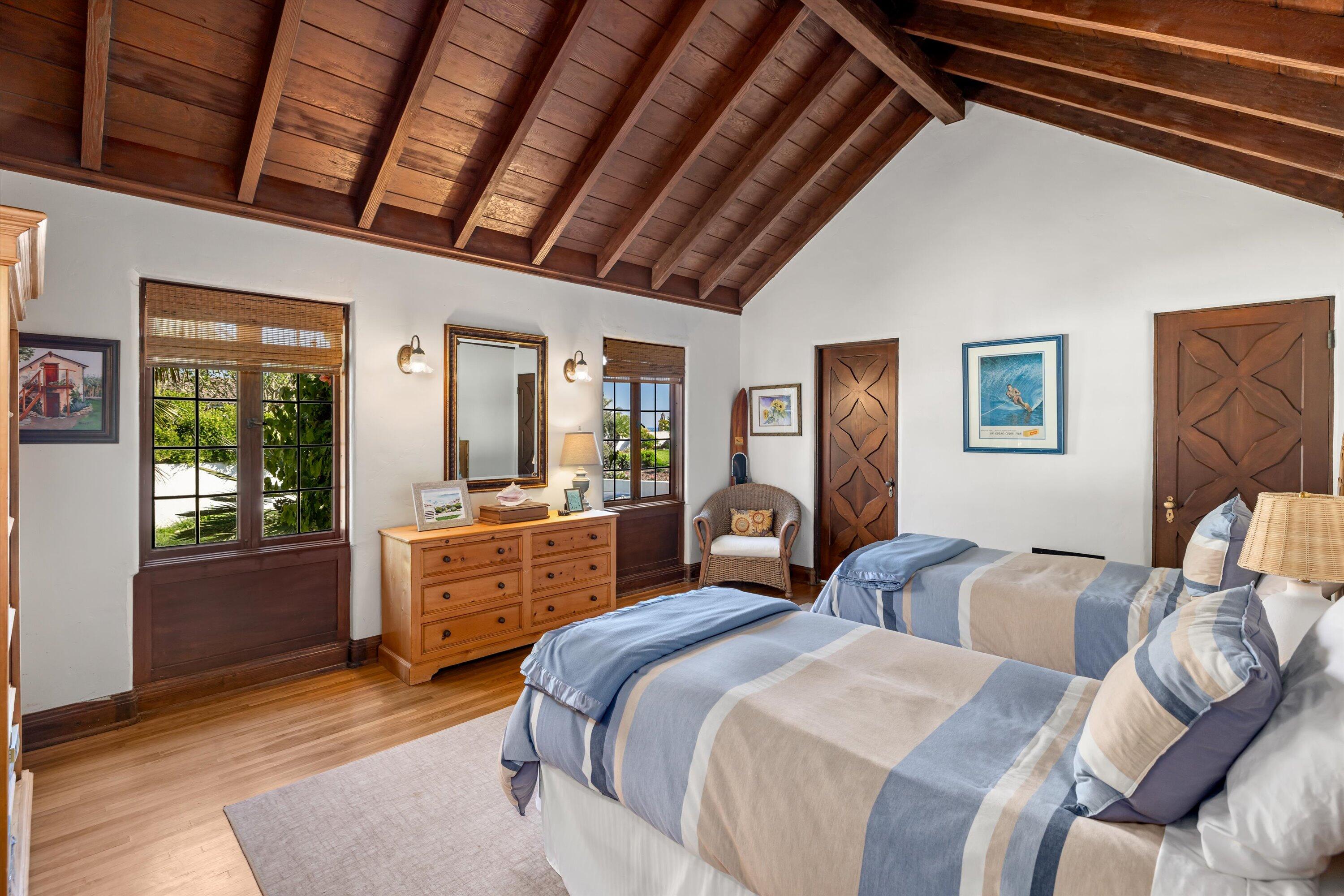 867 Sand Point Road Carpinteria, CA 93013 - Photo 13 of 23 a spacious bedroom with two beds and a dresser