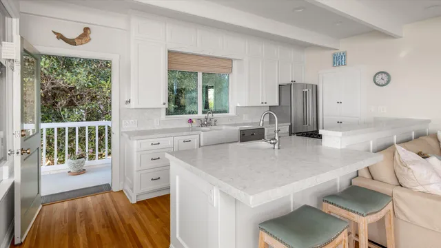 a view of kitchen island with stainless steel appliances cabinets