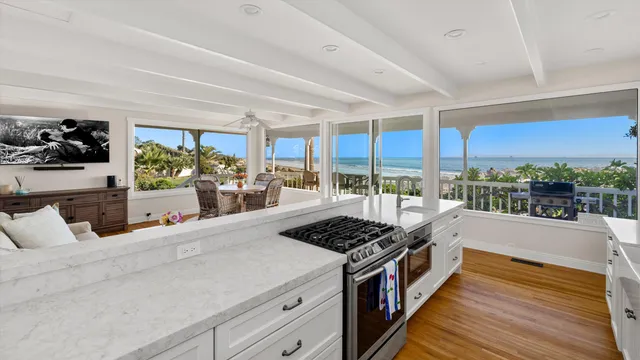a kitchen with stainless steel appliances a stove and wooden floor