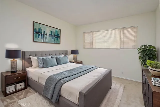 a bed room with a bed and a potted plant