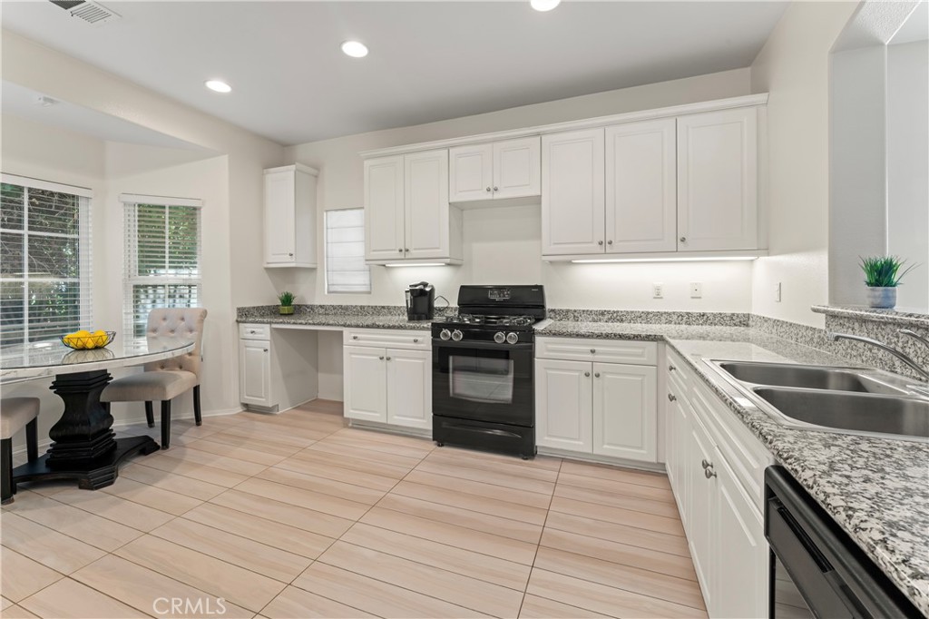 1339 Castledale Street Riverside, CA 92501 - Photo 13 of 27 a kitchen with a sink stove top oven and cabinets